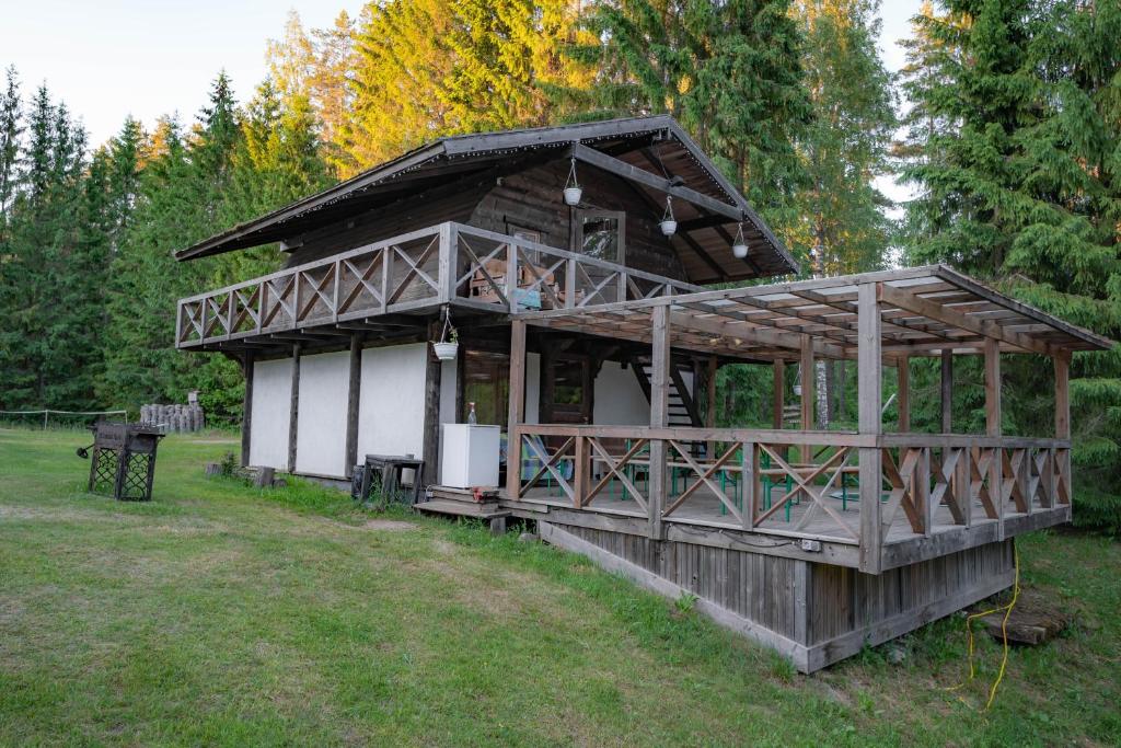 a large wooden house in the middle of a field at Soesauna Farmstay in Vetla