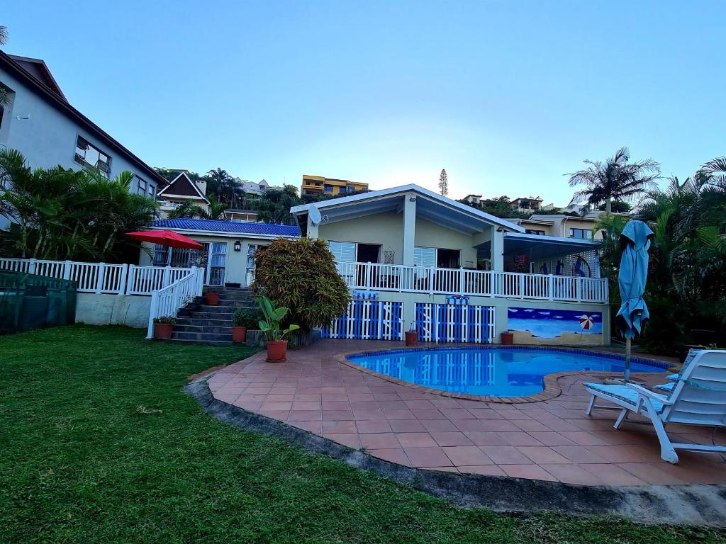 a house with a swimming pool in the yard at Ruby Sands Exclusive Holiday home in Ballito