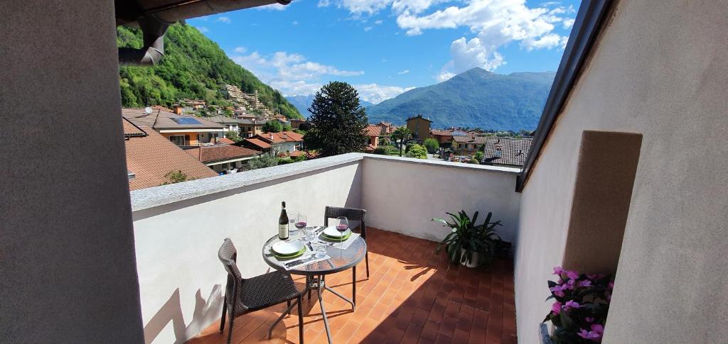a balcony with a table and chairs and a view at Appartamento Little World in Cannobio