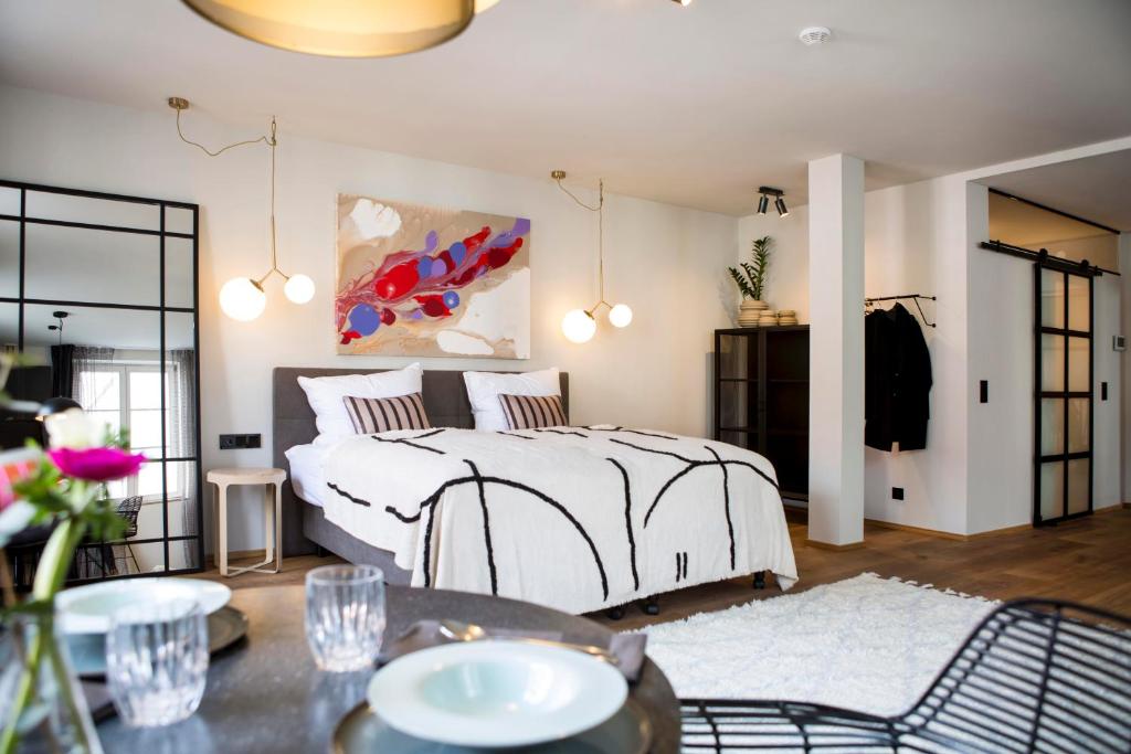 a bedroom with a bed and a table with chairs at Livingloft Apartments in Bad Saulgau