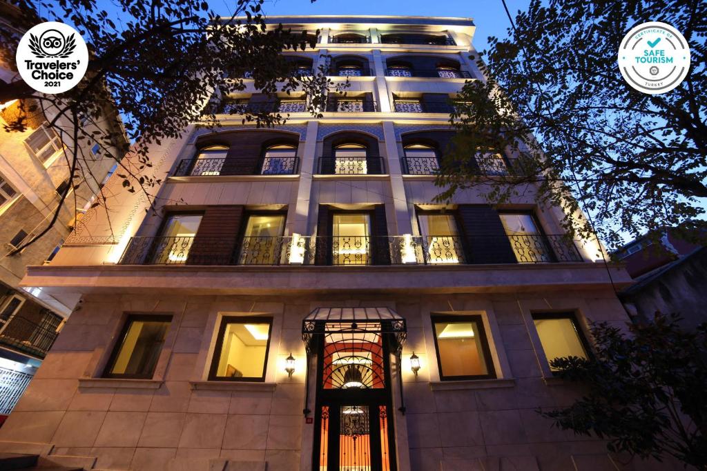 a tall building with a lit up facade at night at The Fox Hotel in Istanbul