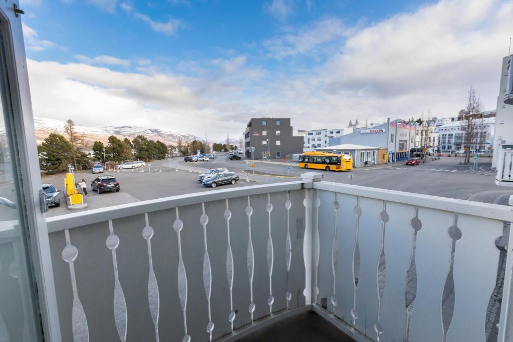 a balcony with a view of a street with cars at Central Apartment with Two bedrooms and Balcony- Strandgata 9 in Akureyri