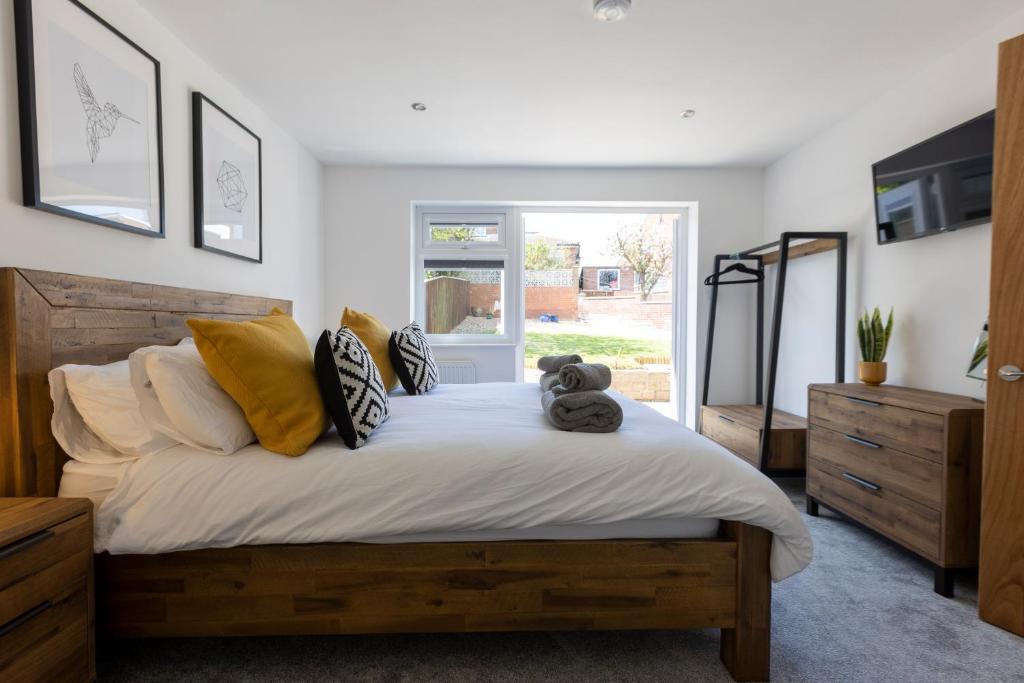 a bedroom with a bed with a teddy bear on it at Fletchers Rest in Whitby