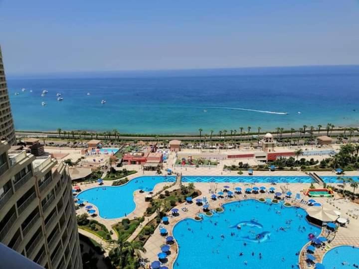 a view of a resort with swimming pools and the ocean at Two-Bedroom Chalet in Pyramids Porto Sokhna in Ain Sokhna