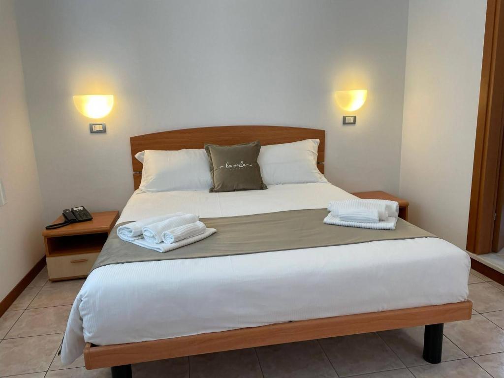 Posteľ alebo postele v izbe v ubytovaní Hotel La Perla