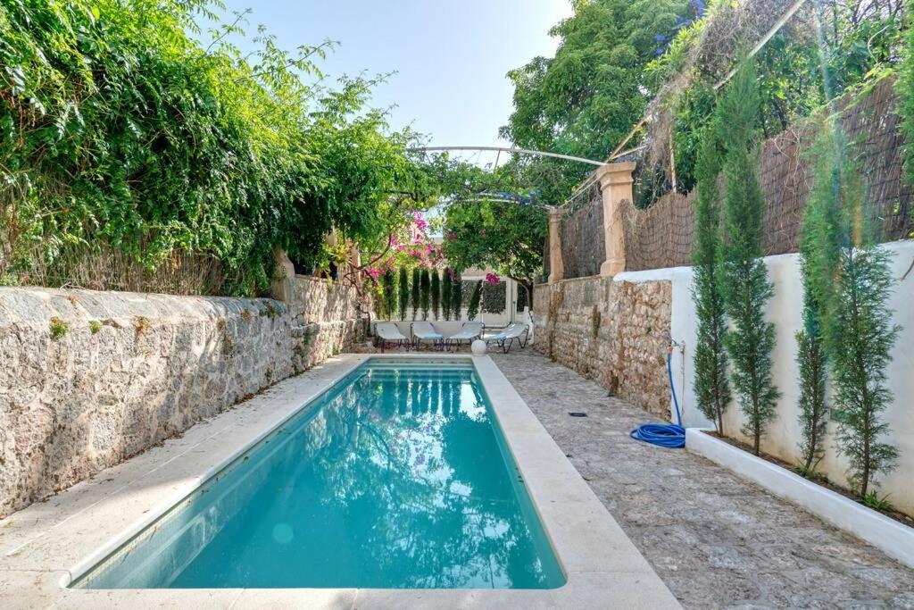 a swimming pool in the backyard of a house at Villa Casasnovas in Sóller