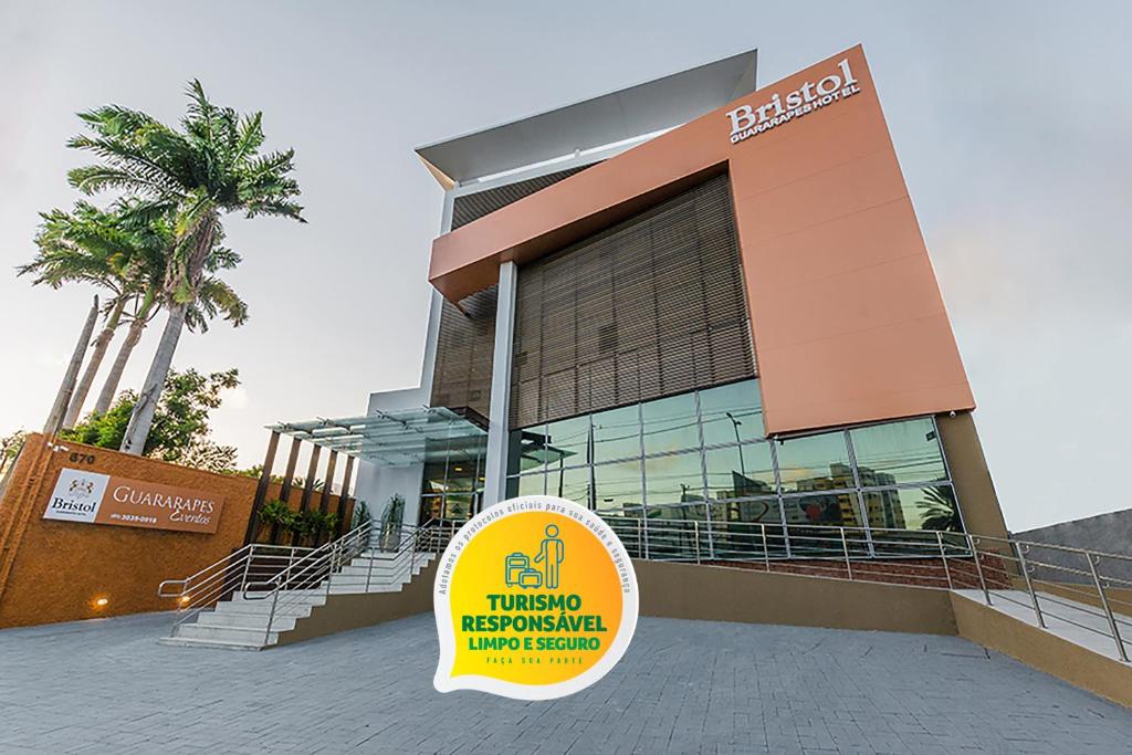 a building with a sign in front of it at Bristol Guararapes Fortaleza Centro de Eventos in Fortaleza