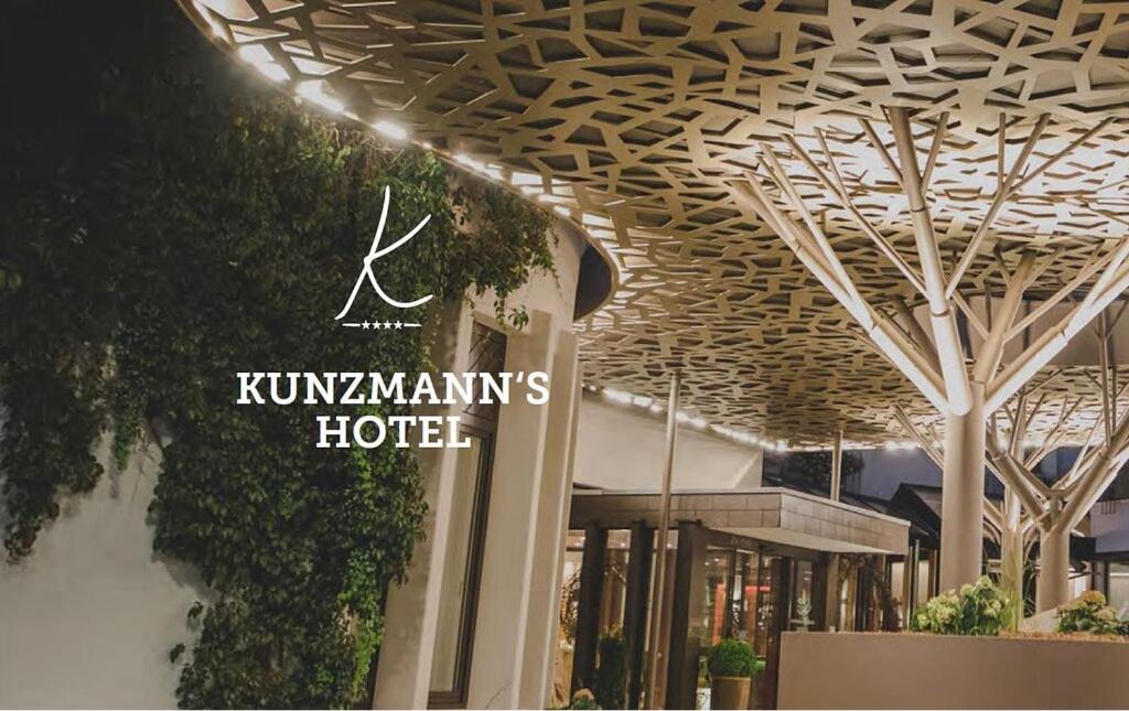 a rendering of a building with a hotel sign on it at Kunzmann's Hotel | Spa in Bad Bocklet