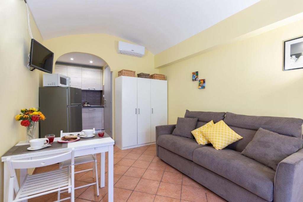 a living room with a couch and a table at Nizza Studio Apartments by Wonderful Italy in Turin