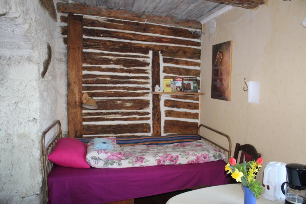 a small bed in a room with a window at Suur-Lossi Apartments in Haapsalu