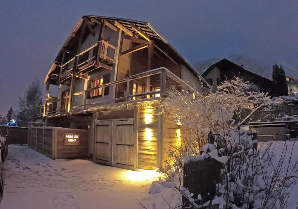 a house with a garage in the snow at night at Serre Che Chalet in Briançon