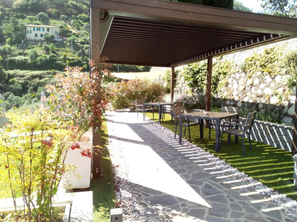 a patio with tables and chairs under a canopy at L'Antico Borgo B&B in Levanto