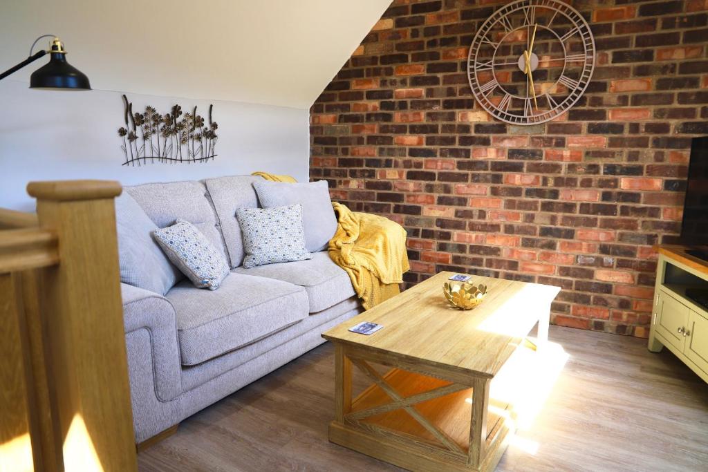 a living room with a couch and a coffee table at Bakers Cottage in Ironbridge