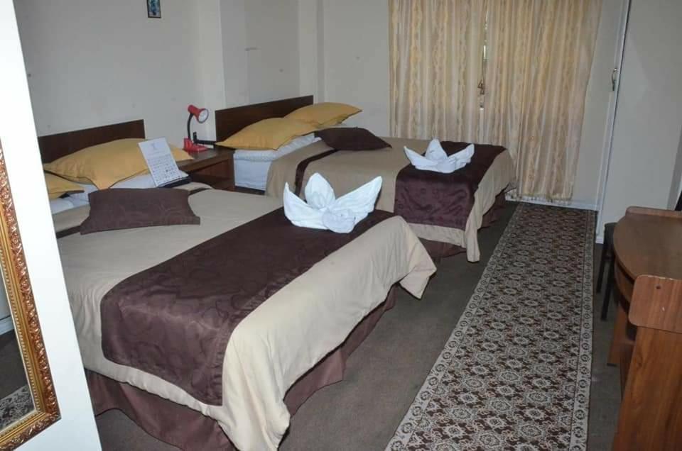 Postel nebo postele na pokoji v ubytování Hotel Bonaventure