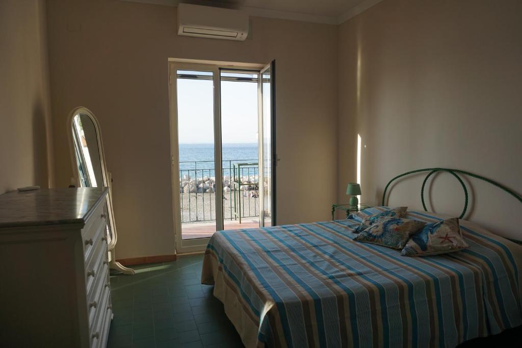 a bedroom with a bed with a view of the ocean at Brezza Marina in Massa Lubrense