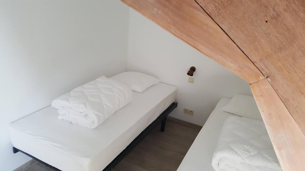 Postel nebo postele na pokoji v ubytování Vakantiewoning onZENhof