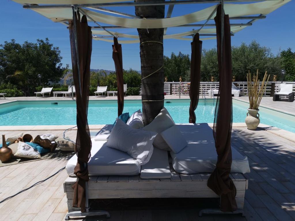 a porch swing by a swimming pool at La Fattoria Dei Nonni in Paterno