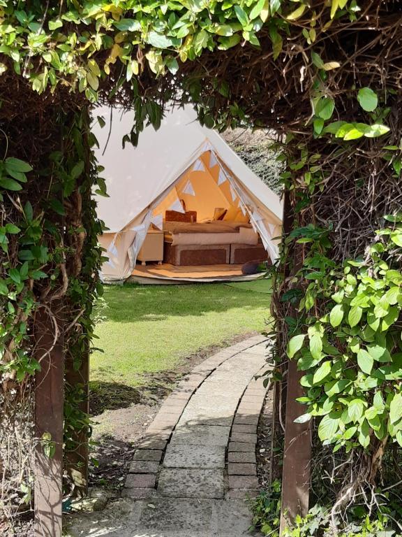 a view of a tent through a tunnel of vines at The White Dove Bed and Breakfast and Bell Tents 1 in Newark upon Trent