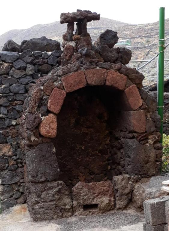 a brick oven with a teddy bear on top of it at Pozo de las Calcosas - El Hierro in Pozo de las Calcosas