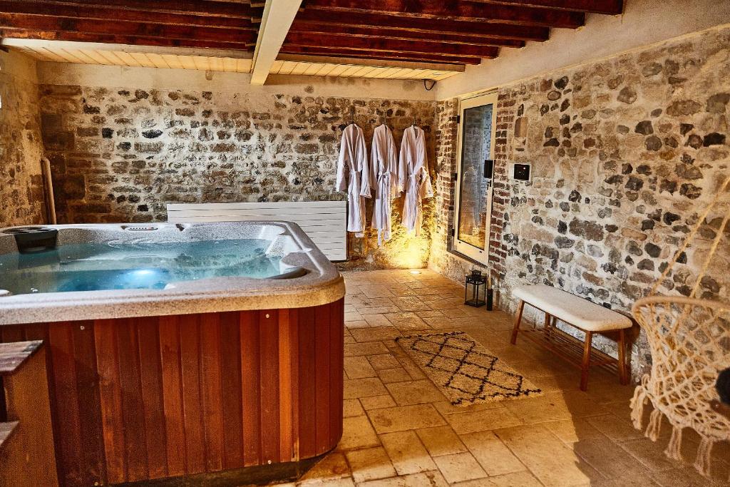 a large bathroom with a hot tub in a room at Demeure de Manneville - SPA - 1Km des plages de Cabourg in Dives-sur-Mer