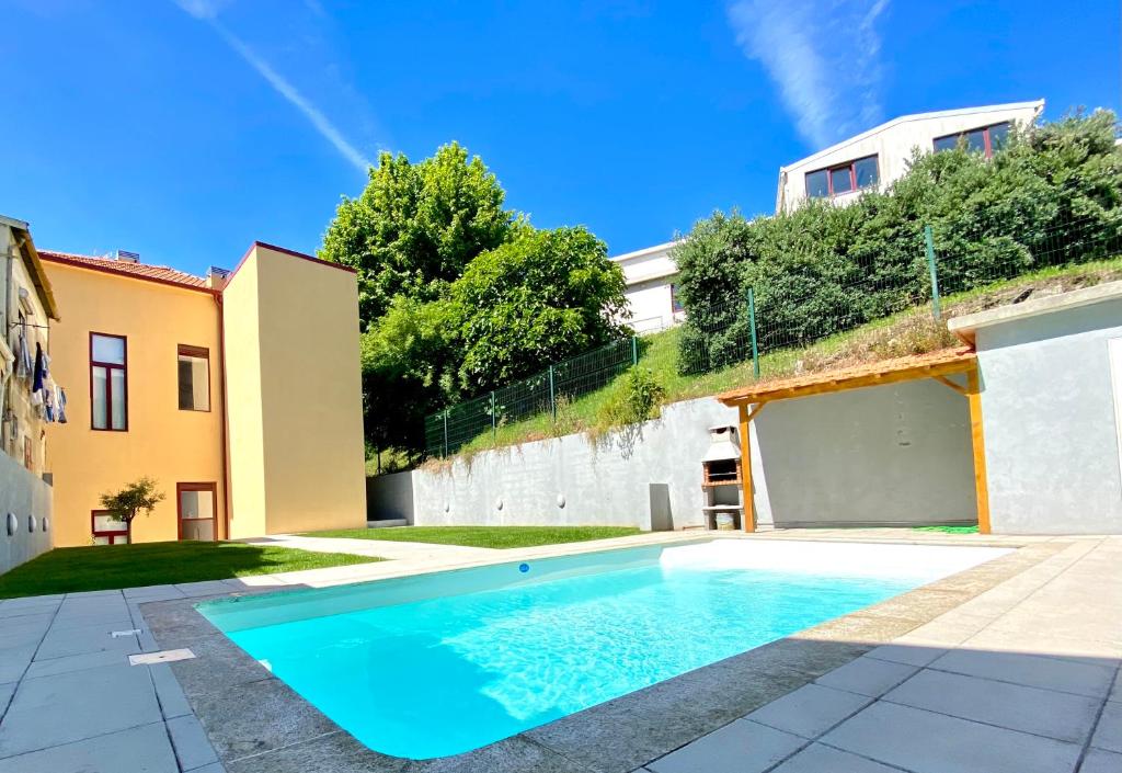 a swimming pool in the backyard of a house at Porto Wine Loft Duplex with swimming pool in Vila Nova de Gaia