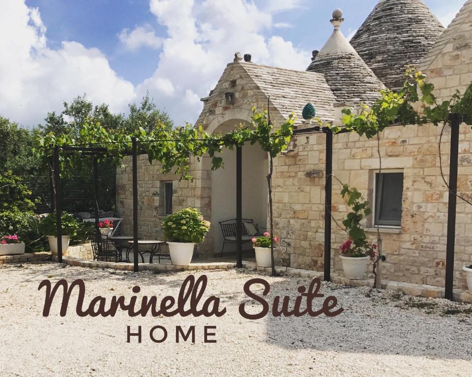 a house with a patio and a sign that reads marmalilla suite home at Marinella Suite Home in Locorotondo