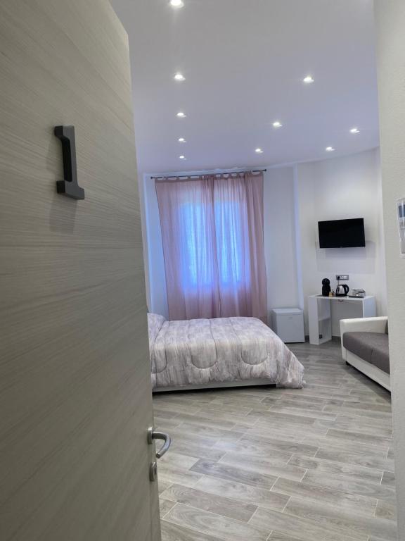 a bedroom with a bed and a couch at Affittacamere La Riviera in Levanto