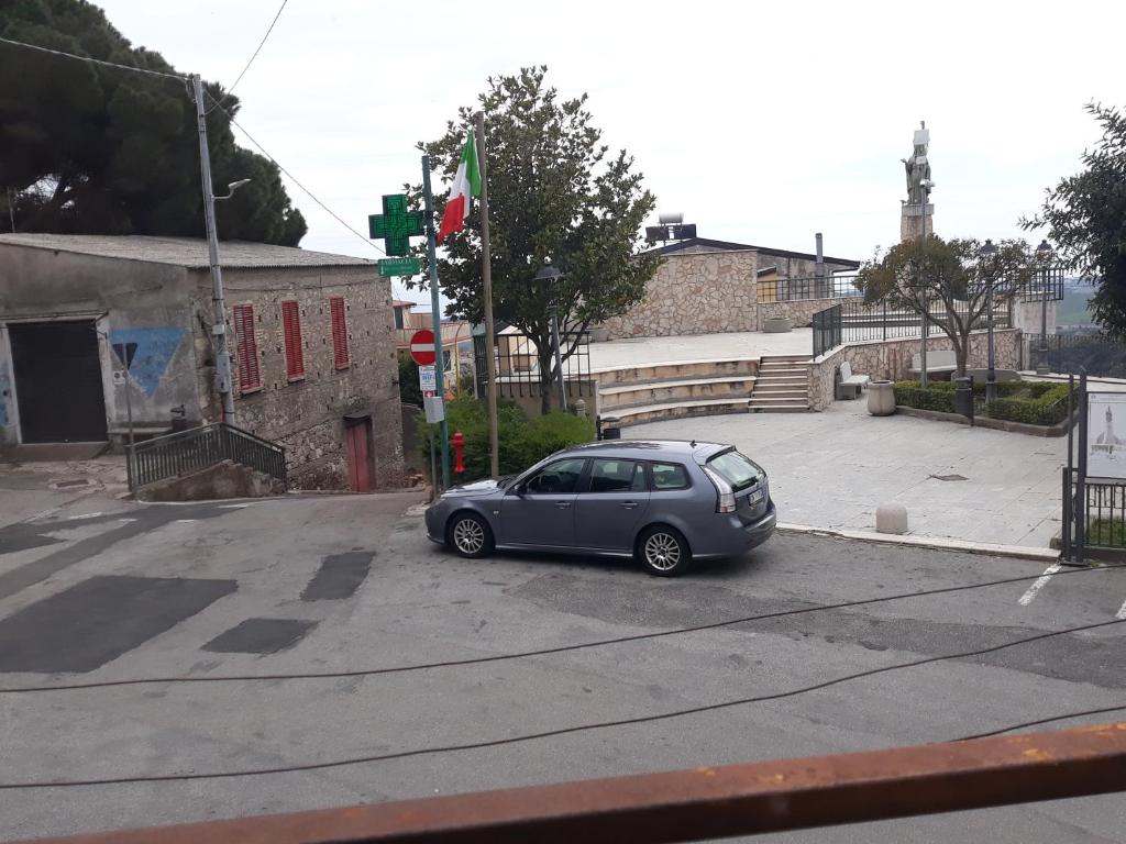 a small car parked in a parking lot at Casetta in centro in Soveria Simeri