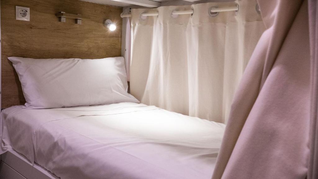A bed or beds in a room at 4U Hostel