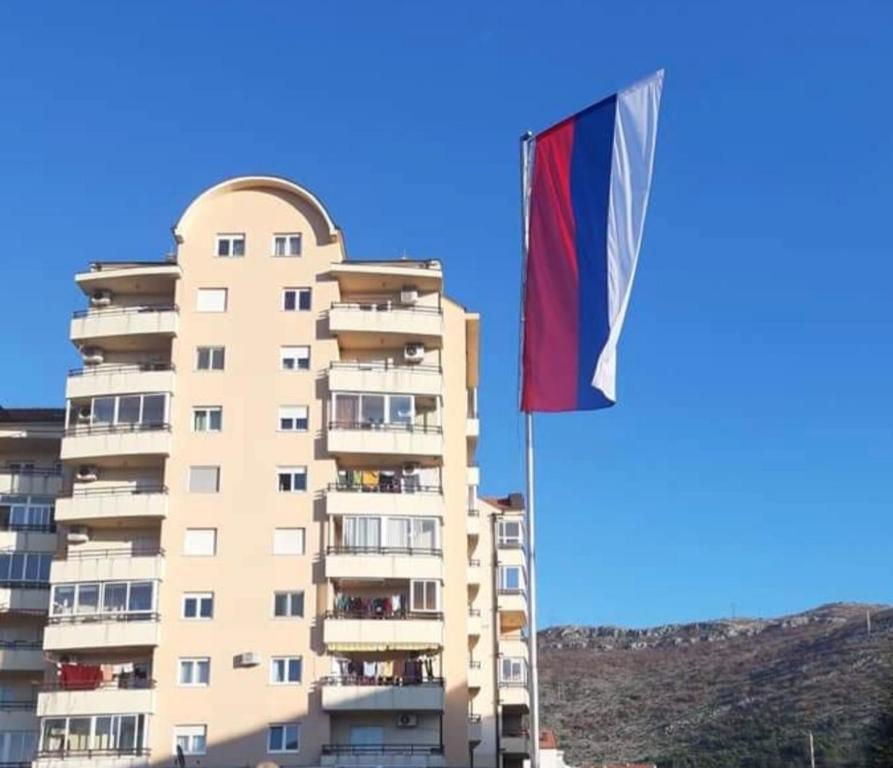a tall building with a flag in front of it at Studio Branka in Trebinje