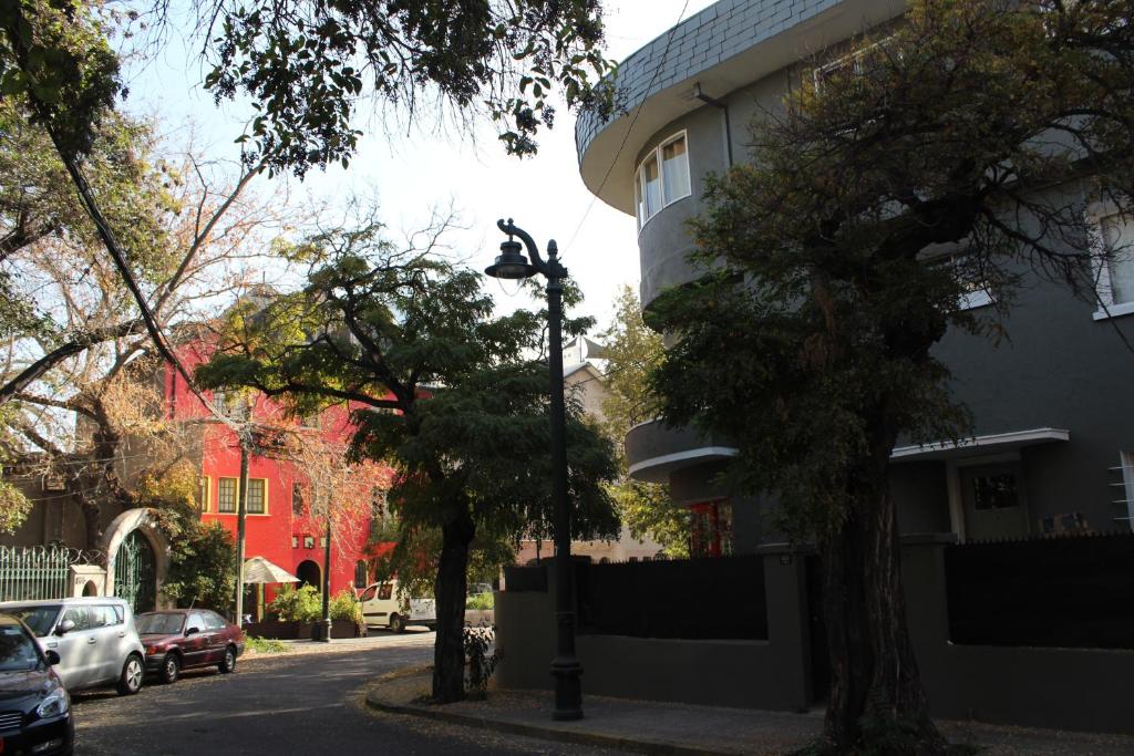 a street with cars parked on the side of a building at Aji Hostel in Santiago
