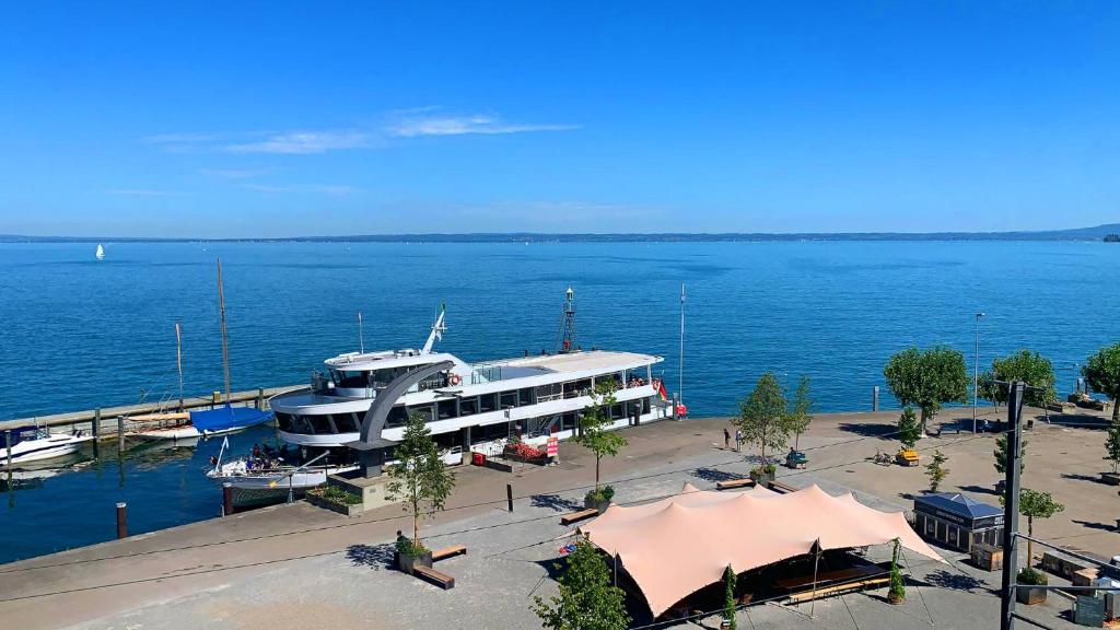 a large boat docked at a dock on the water at Lakeside Apartments Rorschach - easy self check-in in Rorschach