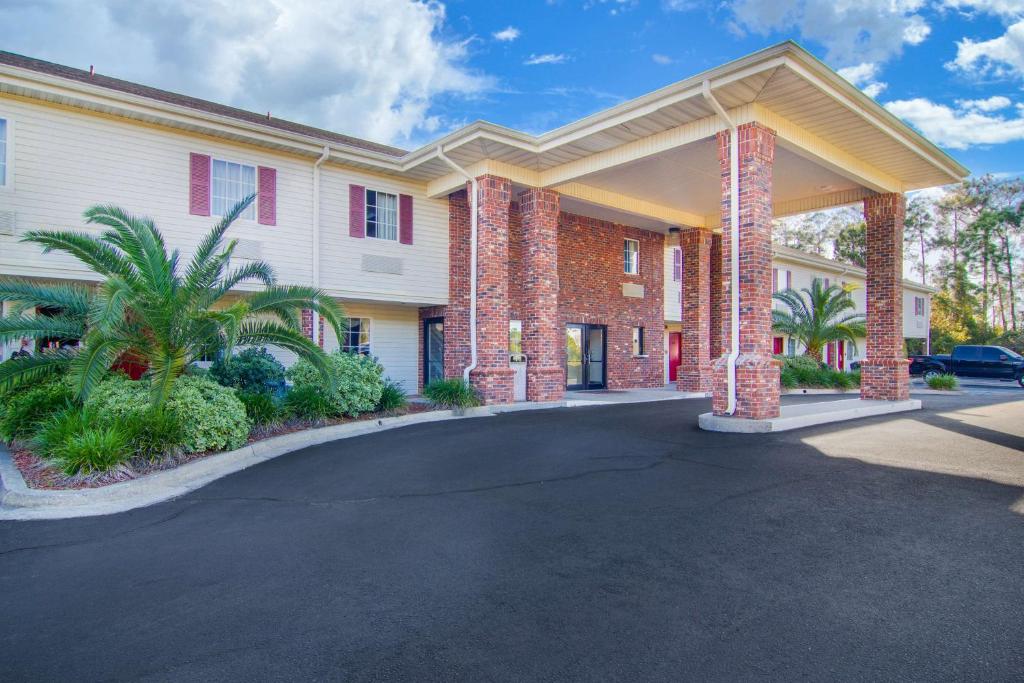 a large building with a driveway in front of it at SureStay Hotel by Best Western Brunswick in Brunswick