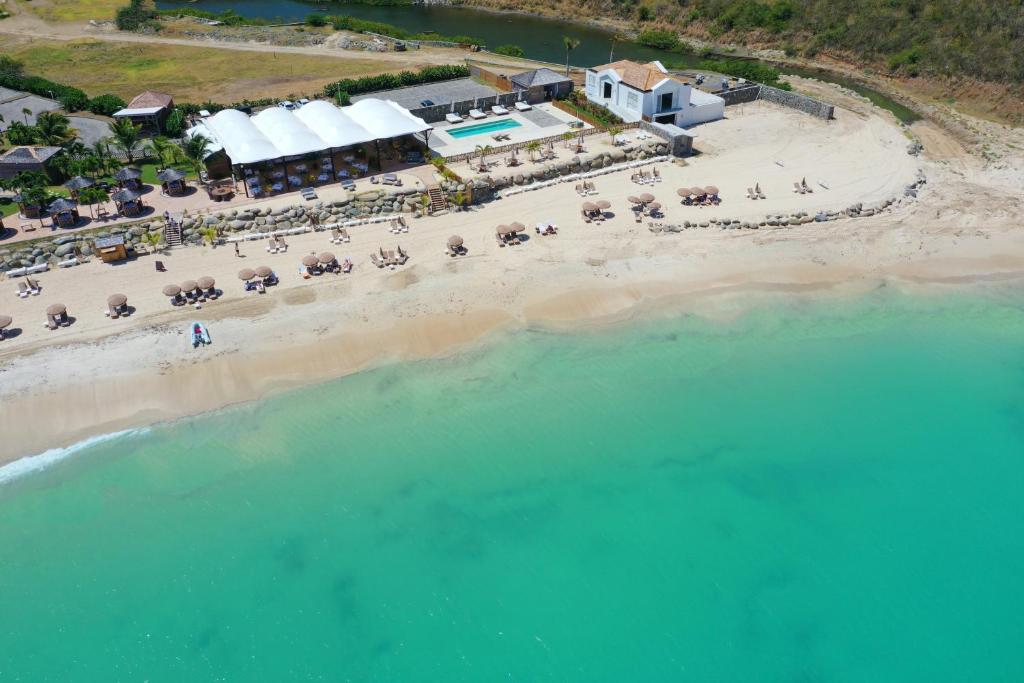 an aerial view of a beach with a resort at Le Domaine Anse Marcel Beach Resort in Anse Marcel 