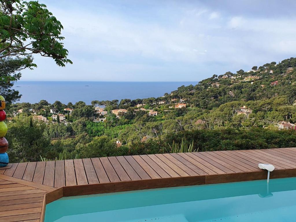 a swimming pool with a view of the ocean at Pretty house with sea view on the Hy res in Hyères