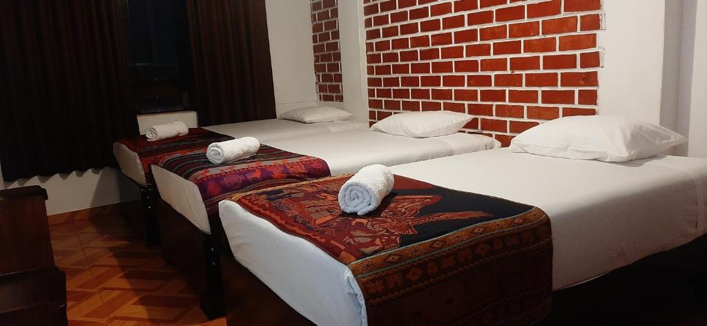 Postel nebo postele na pokoji v ubytování Quipu Hostal