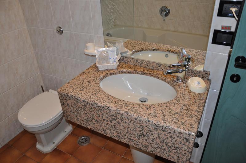 a bathroom with a sink and a toilet at Hotel Bristol in Tirrenia