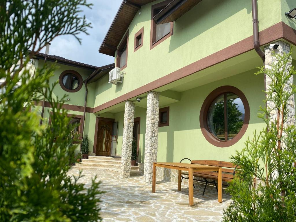 a wooden bench sitting outside of a building at Casa Adelmar in Tulcea