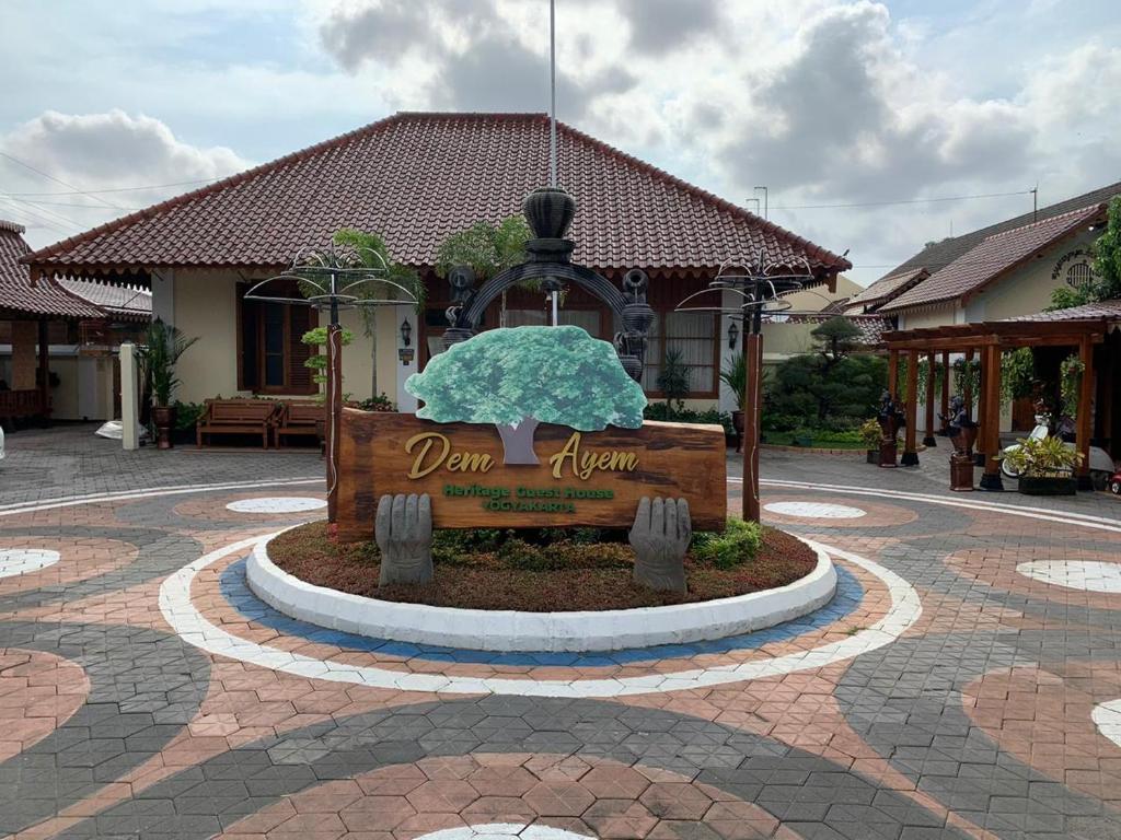 a sign in the middle of a courtyard at Dem Ayem Heritage Guest House in Yogyakarta