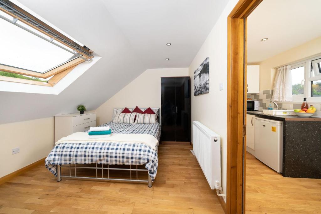 a small bedroom with a bed in a attic at S6 Ensuite Loft Studio Space (Sandycroft Guest House) in London