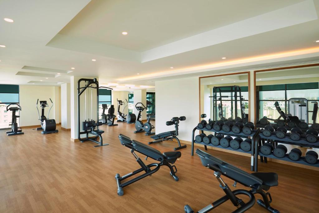 a gym with several treadmills and exercise bikes at Royal Tulip Muscat in Muscat