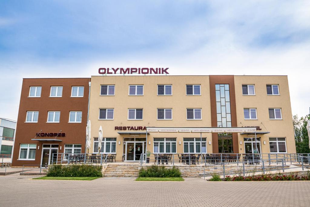 a large building with a clock on the front of it at Hotel Olympionik in Mělník