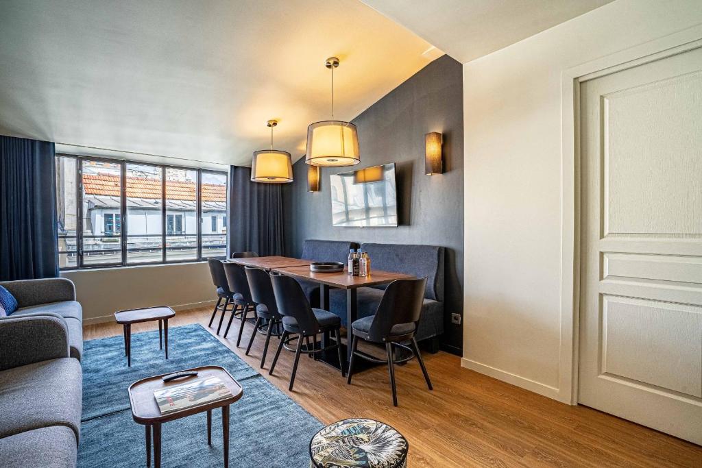 a living room and dining room with a table and chairs at 135 - Urban Five Star Apartment in Center of Paris in Paris