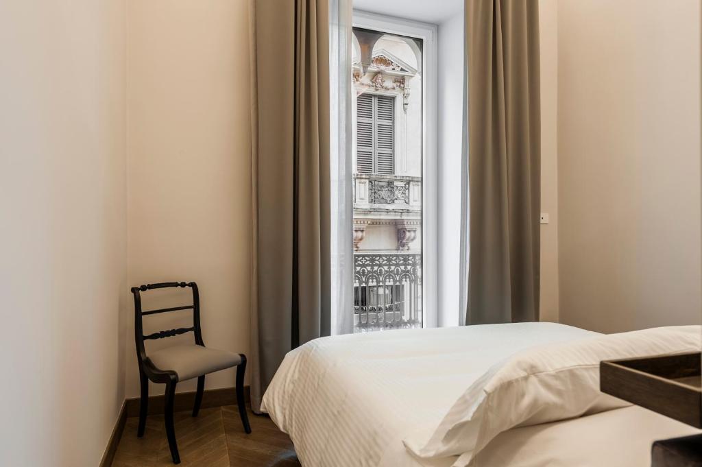 A bed or beds in a room at Ferrini Home - Etnea Portrait