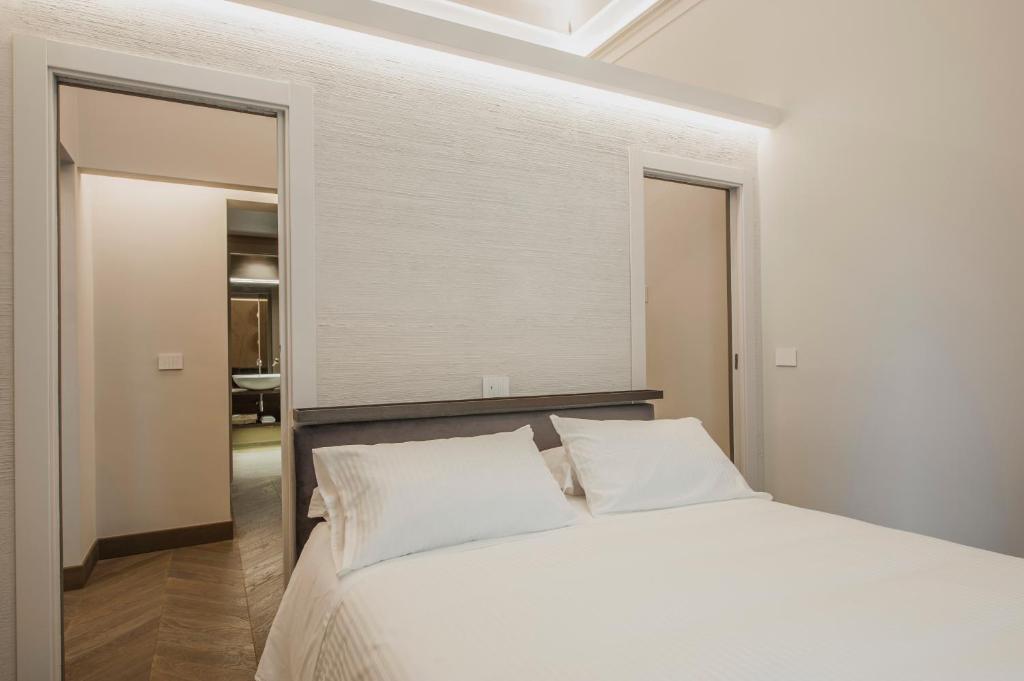 A bed or beds in a room at Ferrini Home - Etnea Portrait