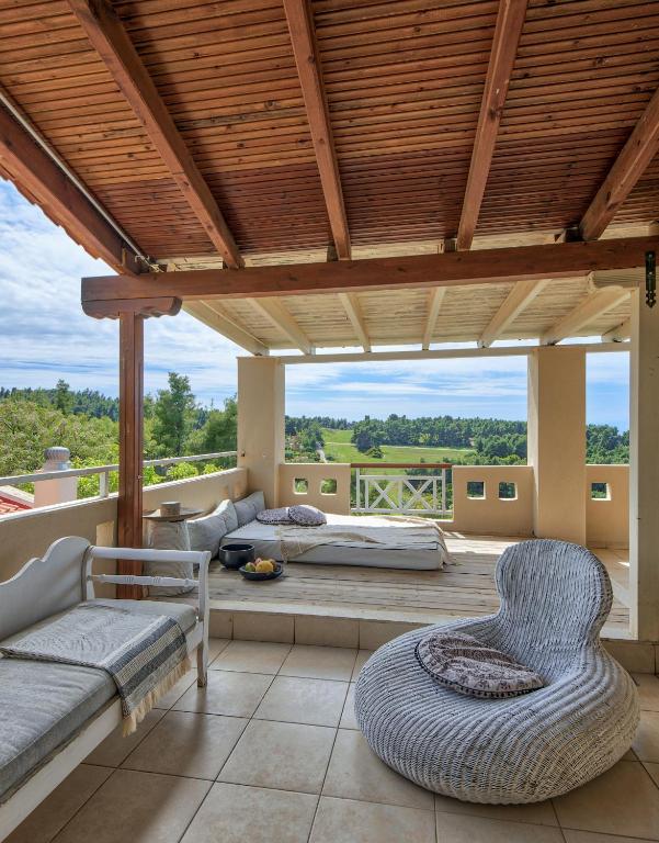 a room with a bed and a couch and chairs at Sanidiamonds in Sani Beach