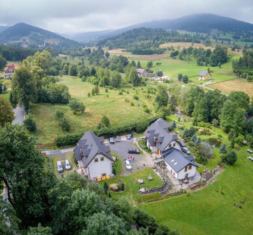 an aerial view of a house in the hills at Indywidualne Gospodarstwo Rolne Agroturystyka Gościniec Pod Czeremchą Małgorzata Szczepanek in Stronie Śląskie