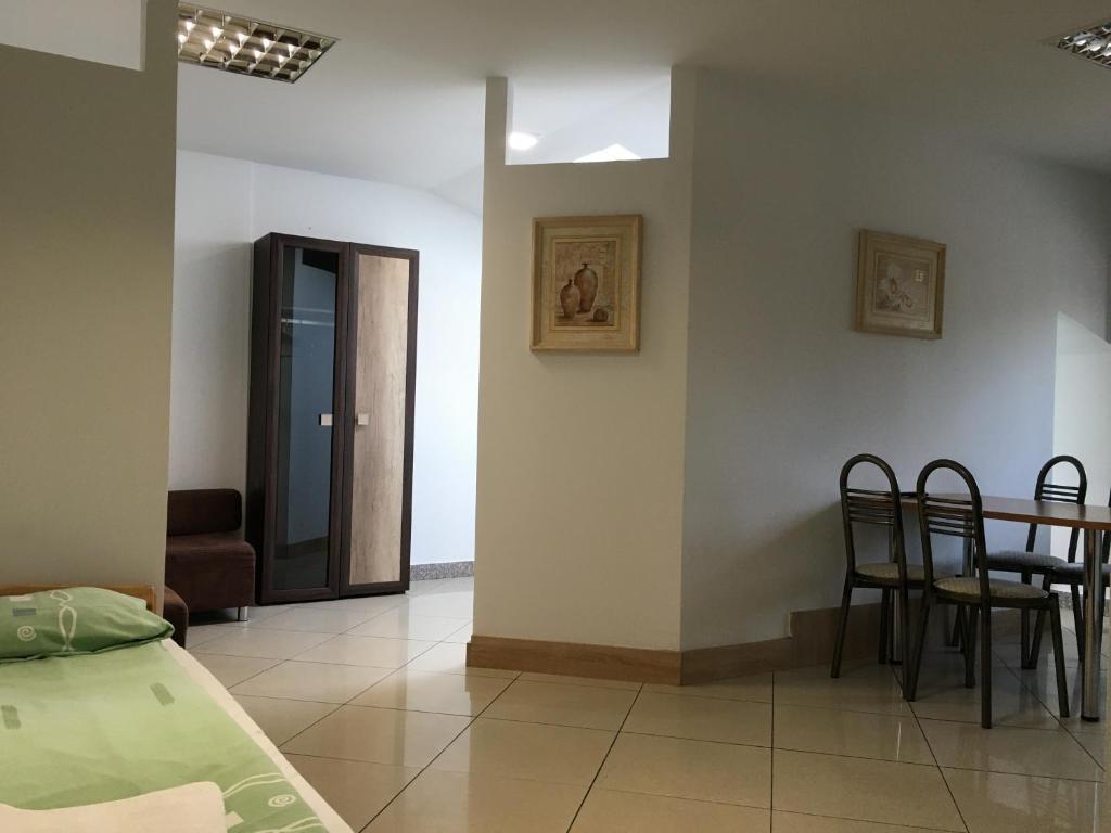 a room with a bed and a table and chairs at Apartamenty w Młynie in Gostynin