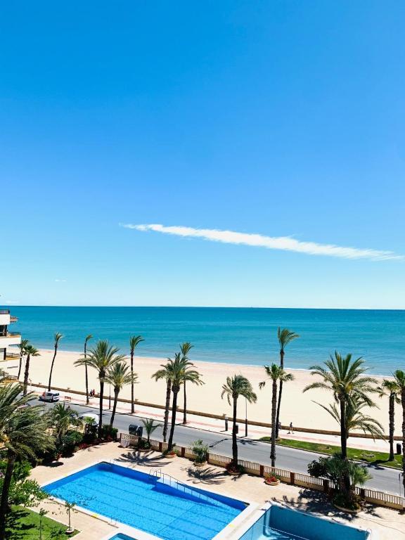 a view of the beach from the balcony of a resort at Apartamento Playa Peñíscola in Peniscola