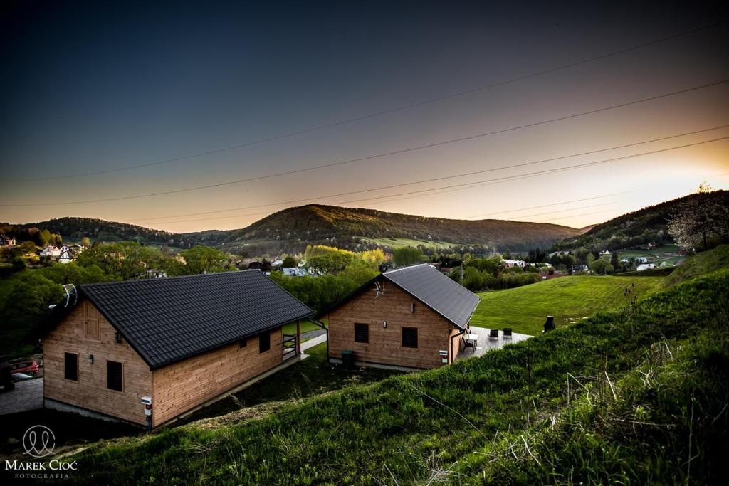a group of houses on a hill with mountains in the background at KaliMera in Solina